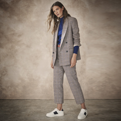 Woman wearing checked pant suit with sneakers